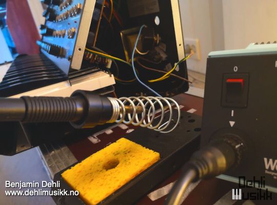 A Korg MS-20 being repaired with a soldering iron